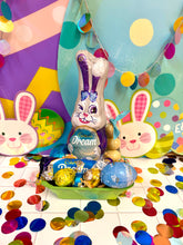 Load image into Gallery viewer, Cadbury Easter basket with chocolate eggs and a plush bunny surrounded by colourful balloons and confetti.
