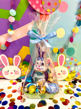 Load image into Gallery viewer, Cadbury Easter basket with chocolate eggs and a plush bunny surrounded by colourful balloons and confetti.
